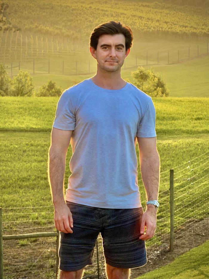 Reid Nicewonder in a vineyard at golden hour